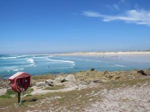 a red mailbox on the side of a beach at penty breton in Pouldreuzic +3 photos