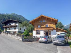 two cars parked in front of a house at Holiday Home Haus Weickl by Interhome in Kaprun