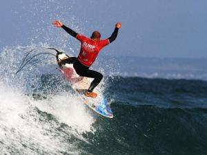 a man riding a wave on a surfboard in the ocean at penty breton in Pouldreuzic