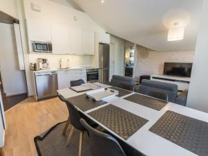 a kitchen and living room with a table and chairs at Holiday Home Levin stara a10 by Interhome in Levi