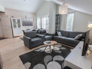 a living room with a couch and a table at Holiday Home Levin stara a09 by Interhome in Sirkka