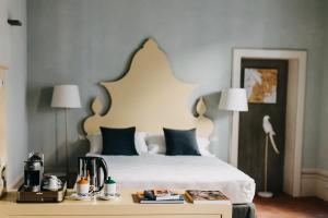 Posteľ alebo postele v izbe v ubytovaní Palazzo Feroci - Residenza d'epoca