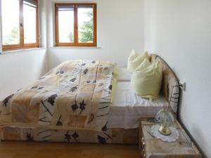 a bed in a white room with a bed sidx sidx sidx at Apartment Dittert by Interhome in Lichtenstein