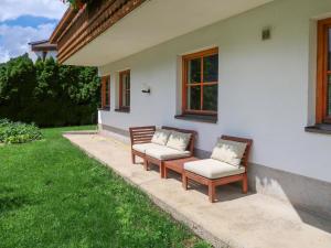 two benches sitting outside of a house at Apartment Appart Vroni by Interhome in Fliess