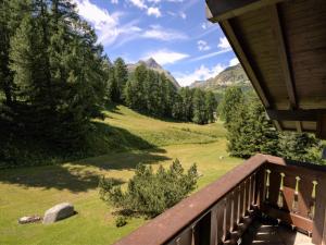 a balcony of a house with a view of the mountains at Apartment Chesa Seglias 6 by Interhome in Surlej