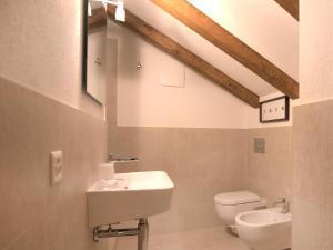 a bathroom with a sink and a toilet at Apartment Chesa Seglias 6 by Interhome in Surlej