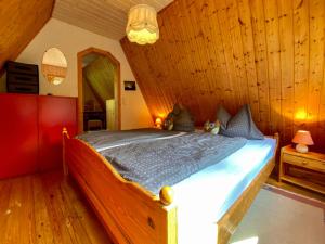 a bedroom with a bed in a room with wooden walls at Holiday Home Gräfenroda by Interhome in Dörrberg