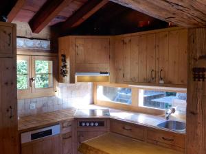a kitchen with wooden cabinets and a sink at Chalet Filaos by Interhome in Verbier +19 photos