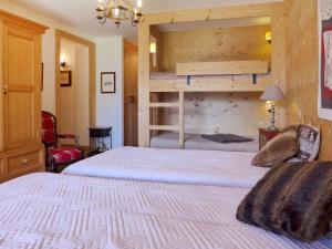 a bedroom with two beds and a bunk bed at Chalet Filaos by Interhome in Verbier