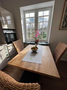 a dining room table with a bowl of fruit on it at Villa am Park in Bremerhaven