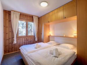 a bedroom with two beds and a window at Apartment Les Cretes II by Interhome in Veysonnaz