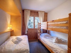 two bunk beds in a room with a window at Apartment Les Cretes II by Interhome in Veysonnaz