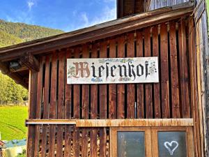 a sign on the side of a wooden building at Apartment Ferienwohnung Wiesenhof by Interhome in Reith bei Seefeld