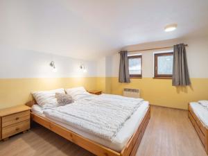 A bed or beds in a room at Holiday Home Dolníky u Trutnova by Interhome