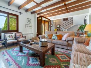 a living room with a couch and a table at Holiday Home Es Rafalet by Interhome in Llucmajor