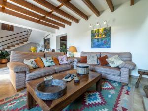 a living room with a couch and a coffee table at Holiday Home Es Rafalet by Interhome in Llucmajor