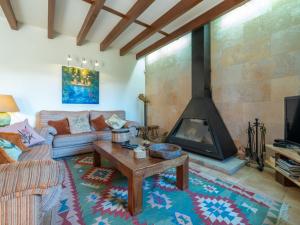 a living room with a couch and a fireplace at Holiday Home Es Rafalet by Interhome in Llucmajor