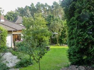 a garden with a tree and a house at Holiday Home Peenetal by Interhome in Relzow