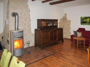 a living room with a wood burning stove in a room at Holiday Home Peenetal by Interhome 