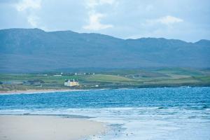 a large body of water with mountains in the background at Balnakeil House in Balnakeil