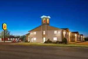 a large building with a clock tower on top of it at Super 8 by Wyndham Liberal KS in Liberal