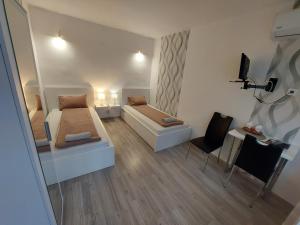 A bed or beds in a room at Palma Vendégház