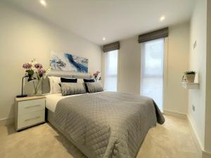 a bedroom with a bed and a large window at Spectacular 2 Bedroom Apartment in Great Location in Sheffield