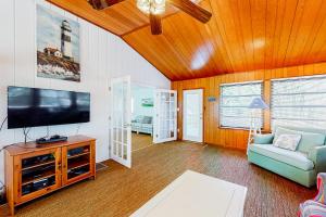 a living room with a flat screen tv and a couch at The Canal -- 337 Sandpiper in Bethany Beach