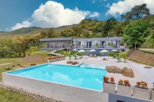 an exterior view of a house with a swimming pool at Santuario Luxury Eco Hotel in Villeta