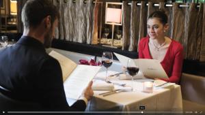 a man and woman sitting at a table with a laptop at Maryborough Hotel & Spa in Cork