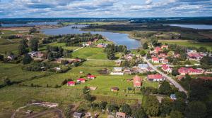an aerial view of a small town next to a river at Siedlisko 14 Chata in Mikołajki