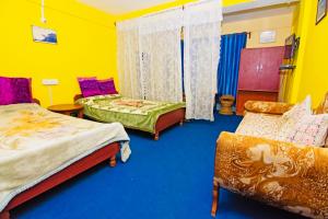 Postel nebo postele na pokoji v ubytování Dew Drop Homestay