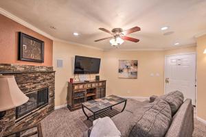 a living room with a couch and a fireplace at Charming Greenwood Village Condo with Patio! in Greenwood Village