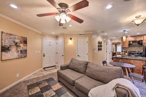 a living room with a couch and a ceiling fan at Charming Greenwood Village Condo with Patio! in Greenwood Village