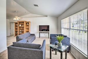 a living room with two couches and a tv at Breezy Cape Coral Oasis, Covered Lanai and BBQ in Cape Coral