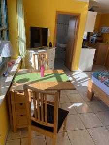 eine Küche mit einem Tisch und einem Esszimmer in der Unterkunft Ferienwohnung auf dem Kutzenberg in Altendorf