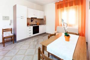 a kitchen with a table and a dining room at Il Terrazzo Di Oleandri in Bagheria