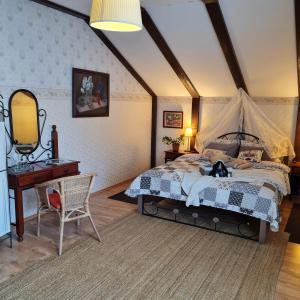 a bedroom with a bed and a desk and a mirror at Бутик-Отель DREAM VILLAGE Oksino in Oksino