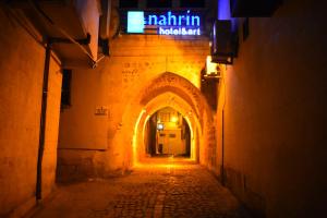 an alley with a sign that saysuthlin hospital at nahrin hotel&art in Sanlıurfa