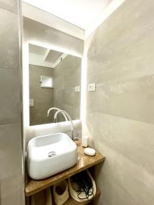 a bathroom with a white sink and a mirror at Residenza Antico Portico in Tivoli +11 photos
