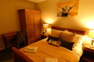 Tempat tidur dalam kamar di Redfearn Cottage