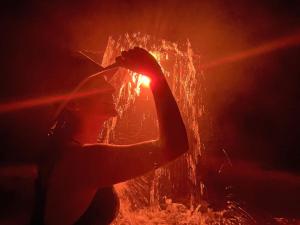 a person is standing in front of a fire at Termales el Escondite in Florencia