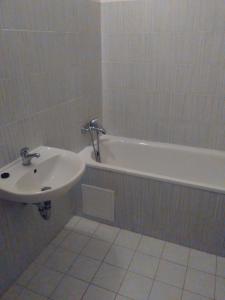 a bathroom with a sink and a bath tub at Hotel Praha Club bed & breakfast in Prague