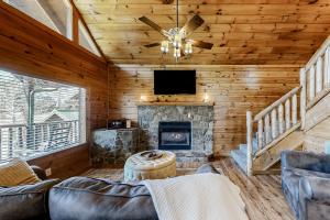 a living room with a fireplace and a tv at Parton Ways in Pigeon Forge