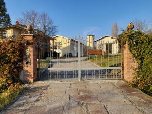 an iron gate to a house with a staircase at Valditerra Vini - B&B La Rombetta in  Tassarolo