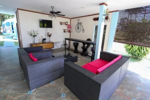 a living room with two chairs and a piano at Atlantis Dome Villa Lot 3108 in Kampong Alor Gajah