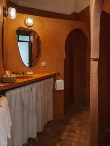 a bathroom with a sink and a mirror at Riad Sierra in Marrakesh