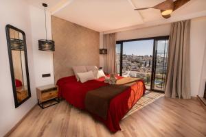 a bedroom with a large bed and a large window at Hostal Casa Mercedes in Nerja