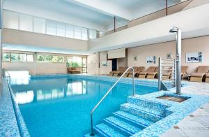 a swimming pool with stairs in a building at Hotel Terme Bologna in Abano Terme