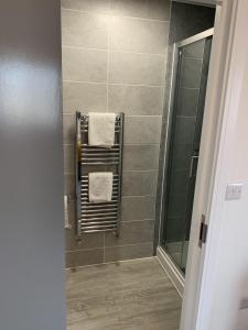 a bathroom with a towel rack and a shower at Paddington by Pureserviced in Plymouth